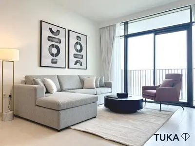 a living room with a couch and a chair at Canal View - 2-BHK - Creek Harbour - Central - Lux in Dubai
