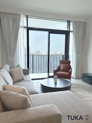 a living room with a couch and a coffee table at Canal View - 2-BHK - Creek Harbour - Central - Lux in Dubai