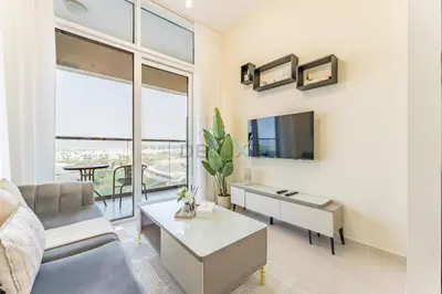 a living room with a couch and a table at Conveniently Located Minutes from Dubai Hills Mall, Park, Golf Club, and Essential City Landmarks 1BR with Premium Facilities, Damac Hills Golf Vita A, Damac Hills 1 by Deluxe Holiday Homes in Dubai