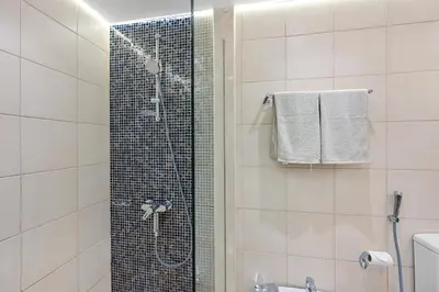 a shower with a glass door in a bathroom at Elegant Private Room at The Palm with Beach & Pool Access in Dubai