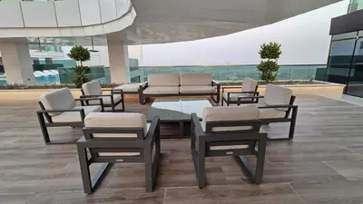 a group of chairs and a table in a building at 1 Residences High-Floor Apt with City View, Al Kifaf in Dubai