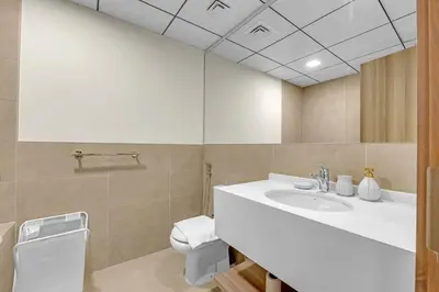 a bathroom with a sink and a toilet at Canal View, Partial Burj Khalifa View, Brand New in Dubai