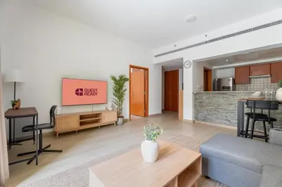a living room with a tv and a couch at GuestReady - Furnished 1BR+Sofa | Al Alka Greens in Dubai