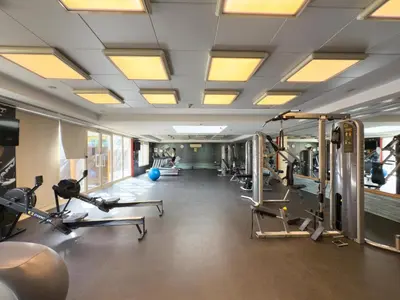 a gym with treadmills and elliptical machines at GuestReady - Furnished 1BR+Sofa | Al Alka Greens in Dubai