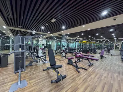 a gym with a lot of treadmills and machines at stylish 1BR Pearlz Pool & Gym Near Metro in Dubai