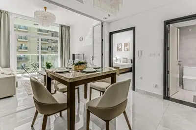 a dining room with a table and chairs at stylish 1BR Pearlz Pool & Gym Near Metro in Dubai