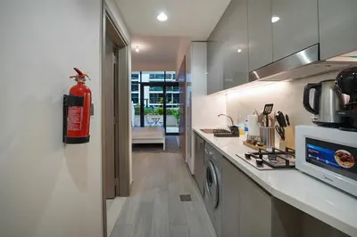 a kitchen with a fire extinguisher on the wall at EasyGo- Spacious, Low Floor and Pool view STU in Dubai