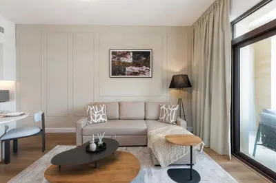 a living room with a couch and a table at Madinat Jumeirah Living 1 Bedroom Holiday Rental in Jadeel 3 - DVH Holiday Homes in Dubai