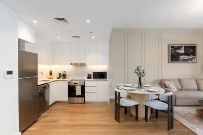 a kitchen and living room with a table and chairs at Madinat Jumeirah Living 1 Bedroom Holiday Rental in Jadeel 3 - DVH Holiday Homes in Dubai