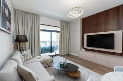 a living room with a couch and a tv at Madinat Jumeirah Living 1 Bedroom Holiday Rental in Jadeel 3 - DVH Holiday Homes in Dubai