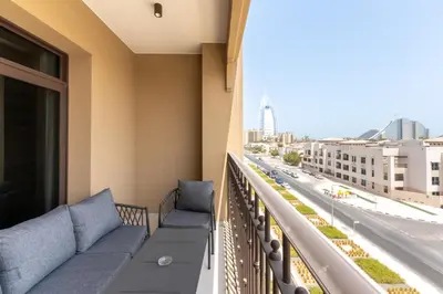 a balcony with couches and a view of a street at Madinat Jumeirah Living 1 Bedroom Holiday Rental in Jadeel 3 - DVH Holiday Homes in Dubai
