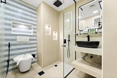 a bathroom with a sink and a toilet and a shower at Luxury 5BR Penthouse in Marina l Private Jacuzzi & Sauna in Dubai