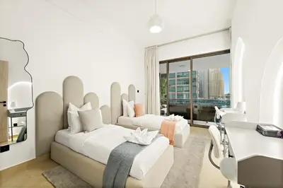a hotel room with two beds and a desk and a window at Luxury 5BR Penthouse in Marina l Private Jacuzzi & Sauna in Dubai