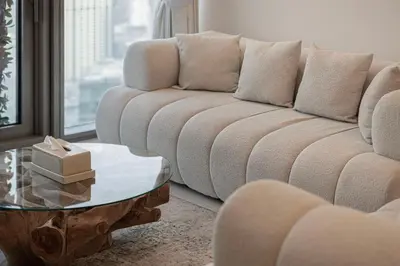 a living room with a couch and a coffee table at Luxury 2BR with Burj Khalifa View l High Floor at Paramount in Dubai