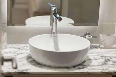 a sink with a faucet on a counter in a bathroom at Luxury 2BR with Burj Khalifa View l High Floor at Paramount in Dubai