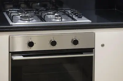 a stove top oven with a black counter top at Luxury 2BR with Burj Khalifa View l High Floor at Paramount in Dubai