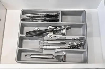 a drawer filled with tools in a white box at Burj Royale Luxury 2BR Burj Khalifa & Fountain View 5 Min Walk Dubai Mall, 500MBPS Wifi in Dubai