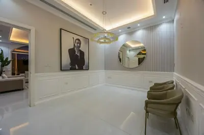 a large white room with a mirror and chairs at Luxury Villa with Pool, Cinema & Spa - Jumeirah Golf in Dubai