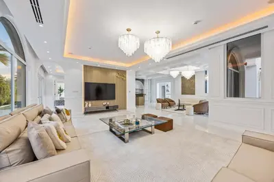 a living room with a couch and a tv at Luxury Villa with Pool, Cinema & Spa - Jumeirah Golf in Dubai