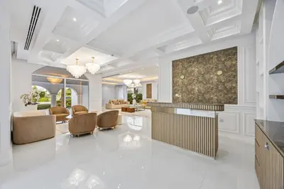 a living room with a large painting on the wall at Luxury Villa with Pool, Cinema & Spa - Jumeirah Golf in Dubai