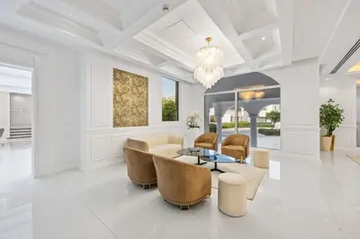 a living room with a chandelier and a table and chairs at Luxury Villa with Pool, Cinema & Spa - Jumeirah Golf in Dubai