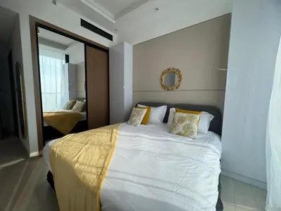 a bedroom with a white bed and a mirror at Stylish 1BR Skyline Views JVC Dubai in Dubai