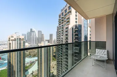a balcony with a chair and a view of the city at Amazing 3BR APT Near Burj Khalifa and Dubai Mall in Dubai