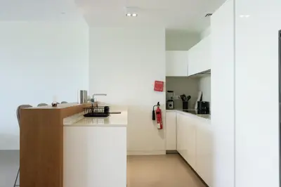 a kitchen with white cabinets and a sink at High-end Beachfront 4BR Duplex with Patio Sea and Burj View in Dubai