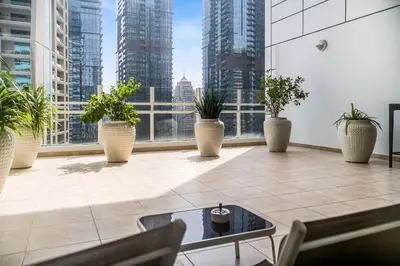 a large room with potted plants and a large window at MAG218 Cozy 1BHK Near Marina Walk in Dubai