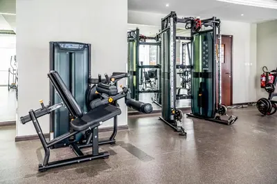 a gym with several tread machines in a room at MAG218 Cozy 1BHK Near Marina Walk in Dubai
