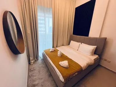a small bedroom with a bed with towels on it at Cozy 1BR apartment in Marina in Dubai
