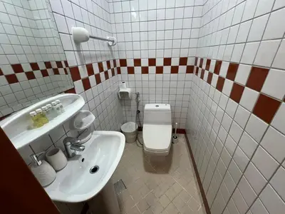 a bathroom with a white toilet and a sink at Cozy 1BR apartment in Marina in Dubai