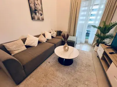 a living room with a couch and a table at Cozy 1BR apartment in Marina in Dubai