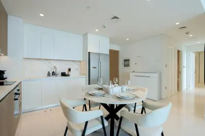 a kitchen and dining room with a table and chairs at Sea View 2B Beachfront Luxury Emaar Beachfront in Dubai