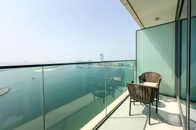 a chair sitting on the balcony of a building at Sea and Palm View 2B Beachfront Luxury Emaar Beachfront in Dubai