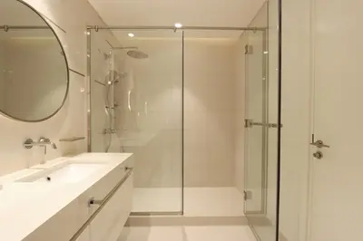 a bathroom with a glass shower and a sink at Sea and Palm View 2B Beachfront Luxury Emaar Beachfront in Dubai