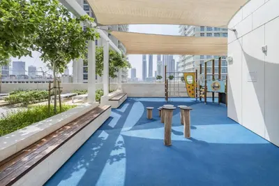 a view of a building with benches and a playground at Sea and Palm View 2B Beachfront Luxury Emaar Beachfront in Dubai