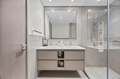 a bathroom with a sink and a mirror and a shower at Luxury 2BR at Signature Grande - Next to Dubai Mall & Burj Khalifa in Dubai