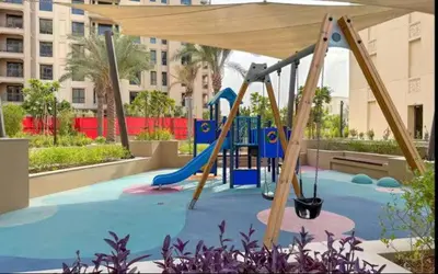 a playground with a slide in a park at Vogue Madinat Jumeirah Living Jadeel near Burj AlArab, Two-Bedroom Apartment with Large Balcony and Pool View, Access to All Amenities in Dubai