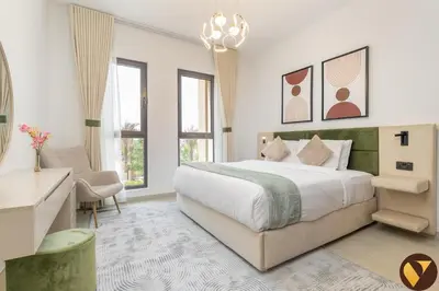 a bedroom with a bed and a desk and windows at Vogue Madinat Jumeirah Living Jadeel near Burj AlArab, Two-Bedroom Apartment with Large Balcony and Pool View, Access to All Amenities in Dubai