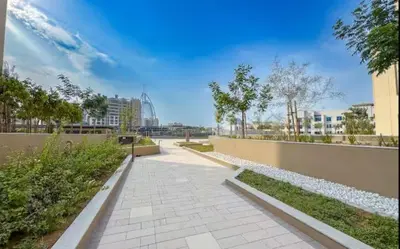 a walkway in a park with buildings and trees at Vogue Madinat Jumeirah Living Jadeel near Burj AlArab, Two-Bedroom Apartment with Large Balcony and Pool View, Access to All Amenities in Dubai