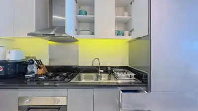a kitchen with a sink and a stove at Stunning Bay View Studio in Center of Dubai in Dubai
