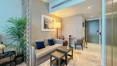 a living room with a couch and a table at Stunning Bay View Studio in Center of Dubai in Dubai