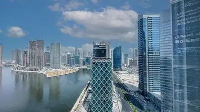 a bridge over a river in a city with buildings at Stunning Bay View Studio in Center of Dubai in Dubai