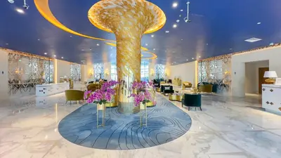 a lobby with a large tree with purple flowers at Stunning Bay View Studio in Center of Dubai in Dubai