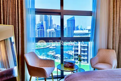 a room with a large window with a view of a harbor at Barsana - Premier 3Bed Suite - Marina & Sea Views in Dubai
