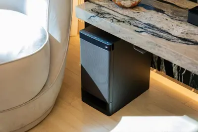 a speaker under a table next to a toilet at Elite Escape - 1 BHK Getaway in Azizi Riviera 18 in Dubai