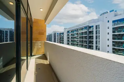 a balcony with a view of some buildings at Elite Escape - 1 BHK Getaway in Azizi Riviera 18 in Dubai
