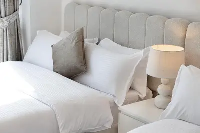 a bedroom with a bed with white pillows at Luxury 2BR Sea Burj views Khalifa infinity pool in Dubai