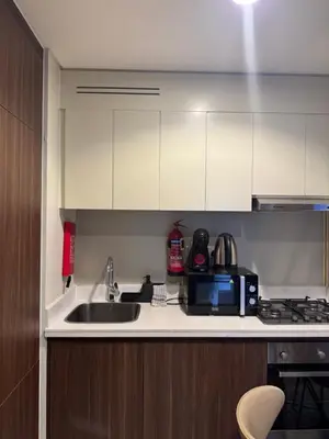a kitchen with a sink and a microwave at Apartment Downtown Dubai in Dubai